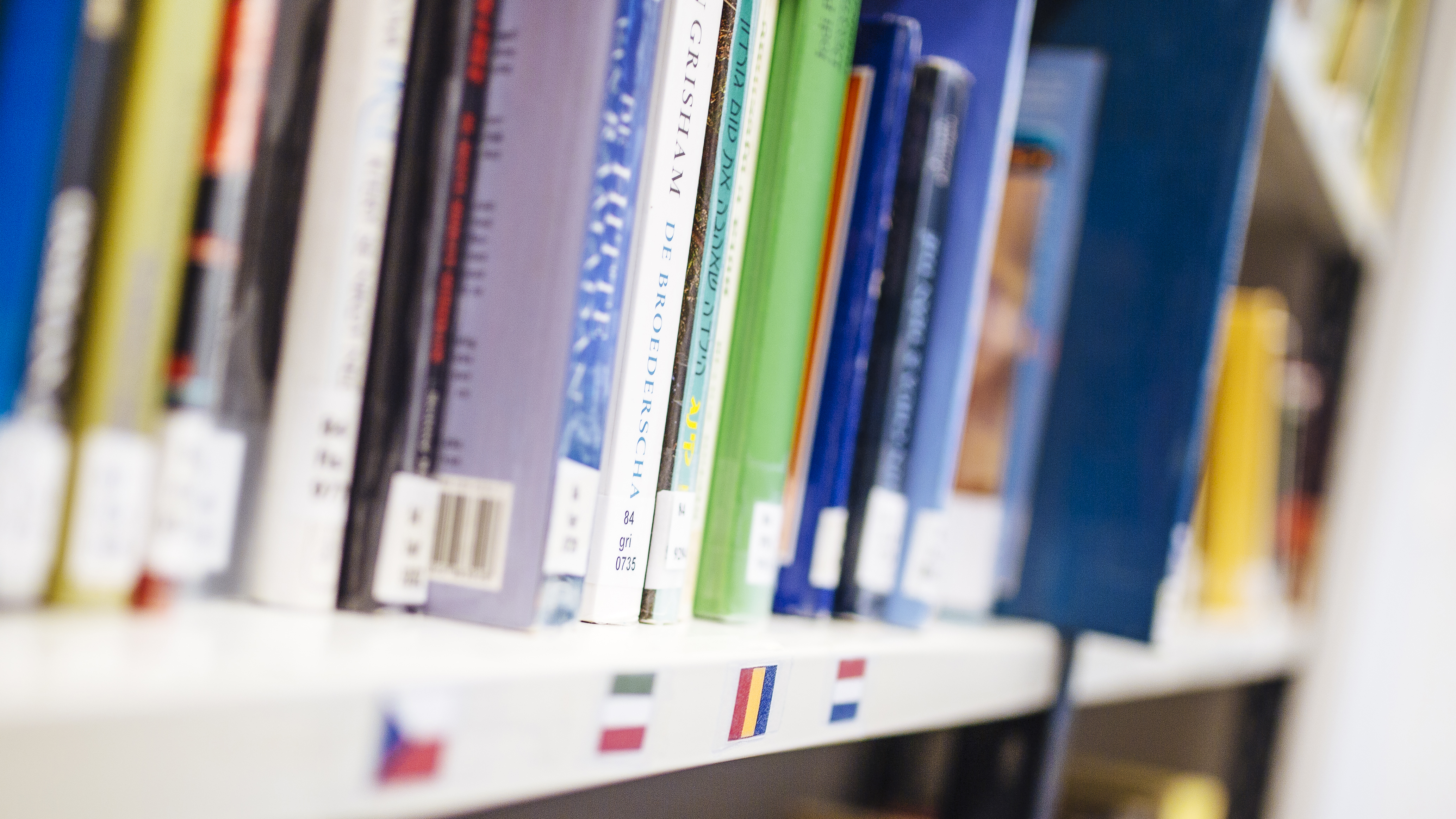 Books in a bookself in library. Books in a bookself in library.