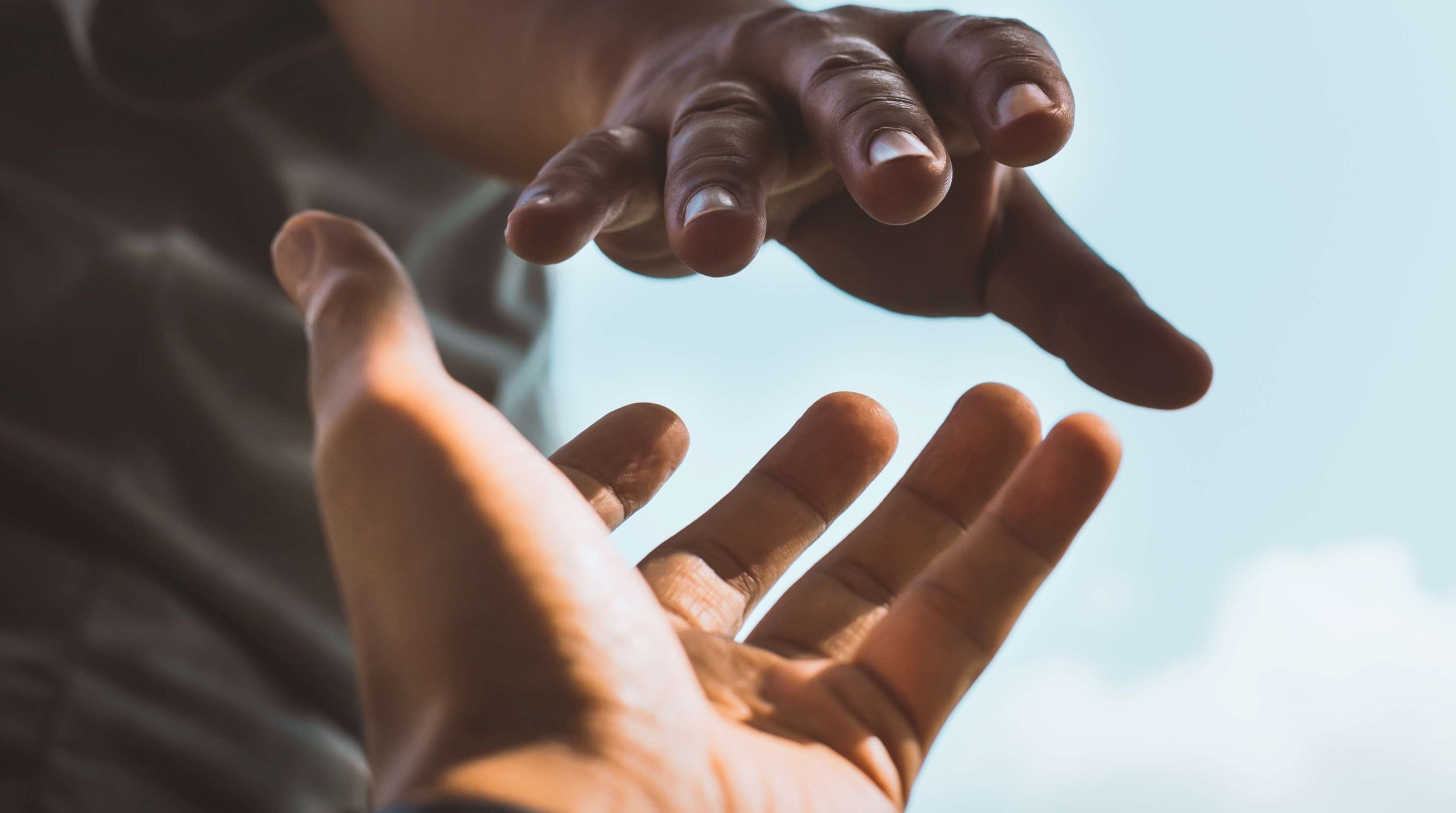 Two hands clasping each other.